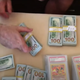 Gary Haase shows off a portion of money gained from selling stakes in the Charizard card collection.